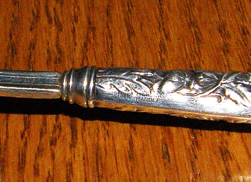  ,     Sterling Handle Floral Repousse